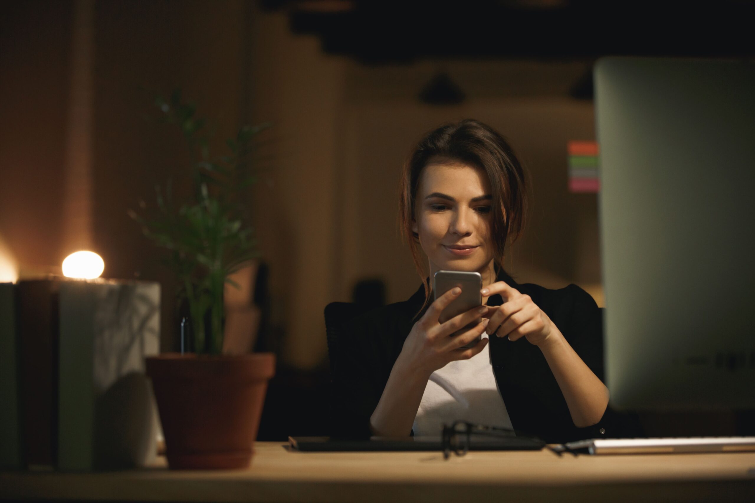 pretty-young-woman-designer-sitting-indoors-chatting-by-phone